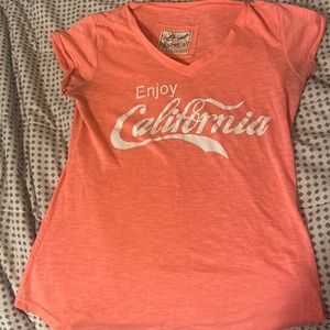 A pink Coca Cola shirt